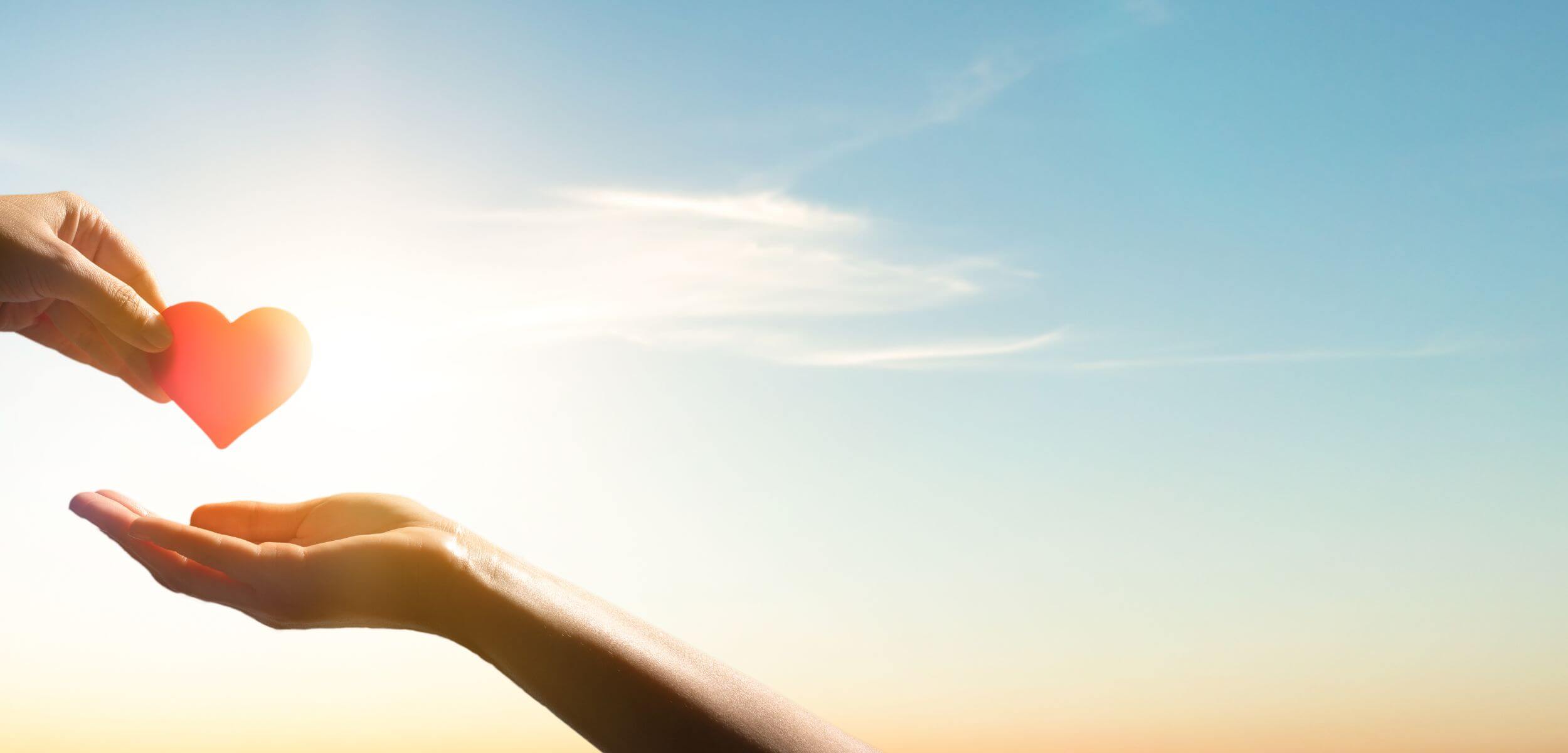 hands exchanging red heart