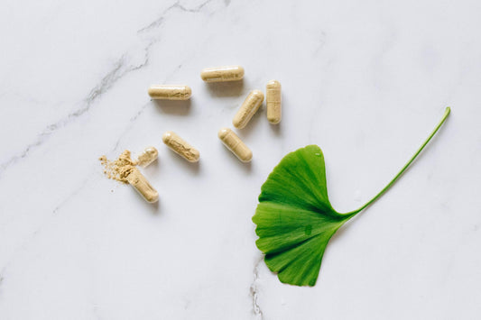 vitamin capsules on surface with powder and natural leaf